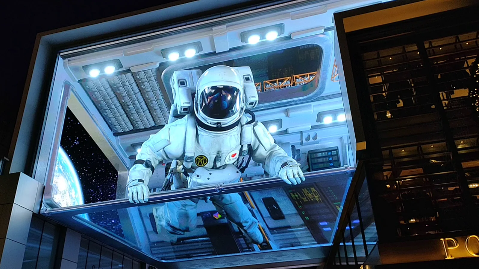 Naked-eye 3D LED display showing an astronaut visual on a large corner screen