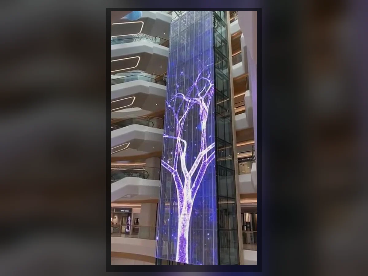 Transparent LED display integrated with a tall atrium column