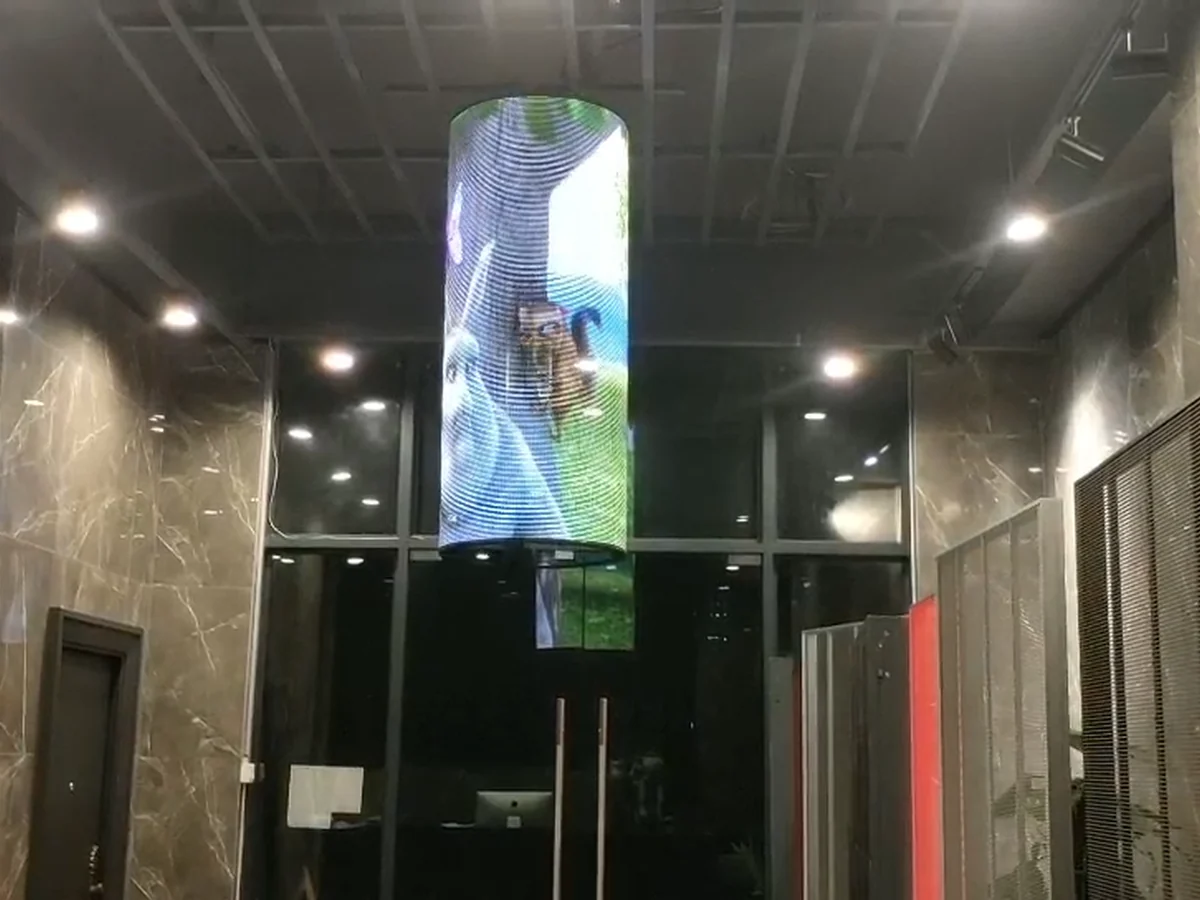 Cylindrical transparent LED display in an indoor lobby