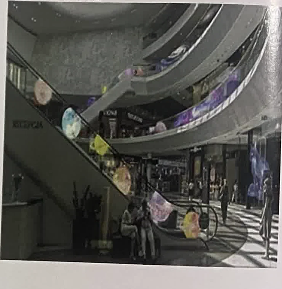 Transparent LED film product reference beside an escalator