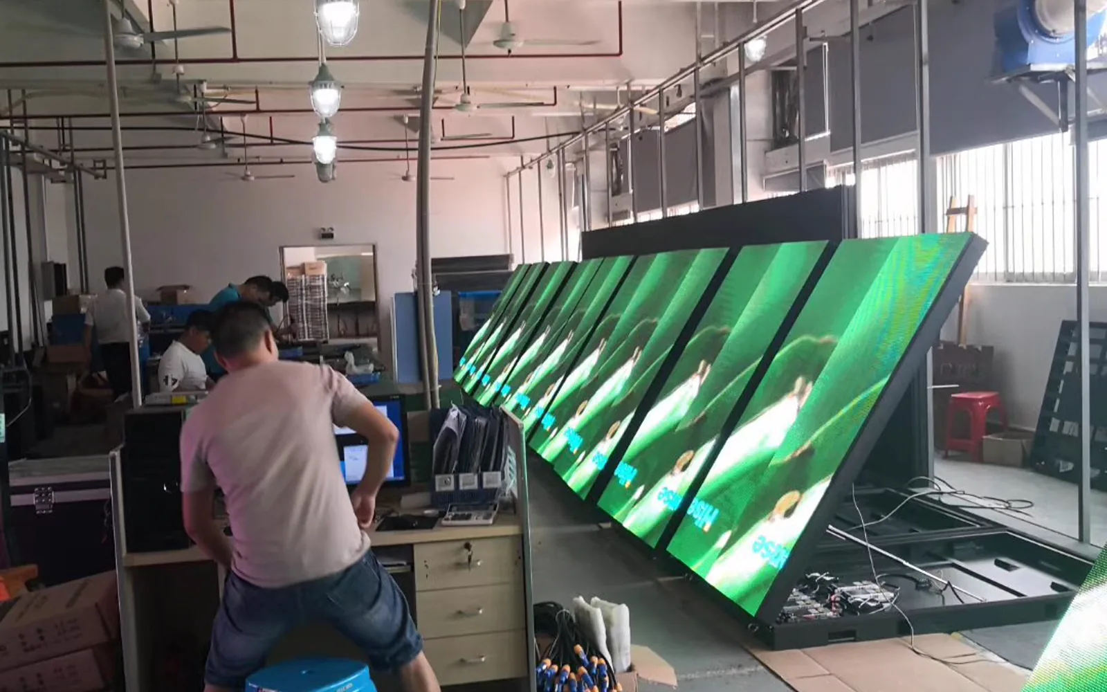 Technician working on an assembled LED display