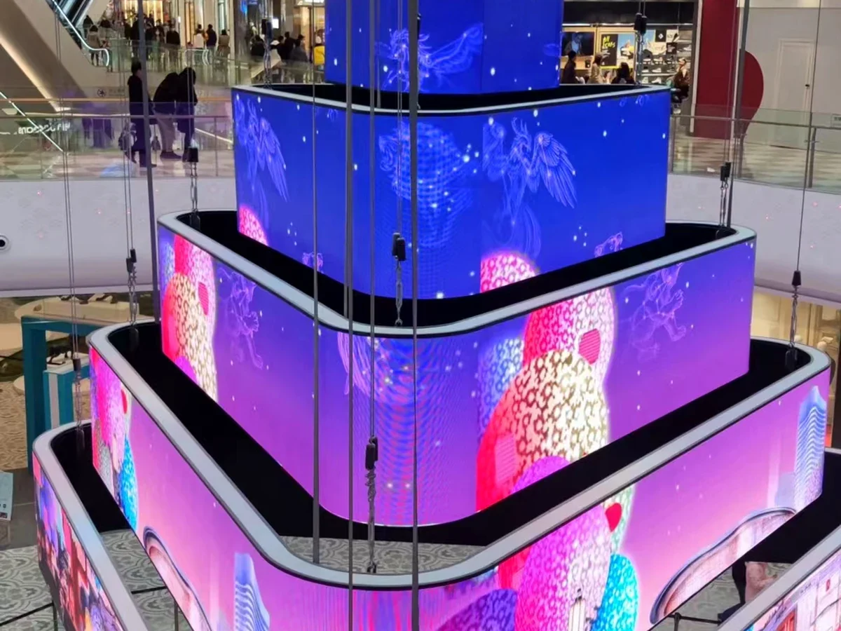 Layered curved LED display installed as a large retail atrium feature